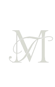 Elegant monogram logo featuring the letters “M” and “T” intertwined in a calligraphic serif style on a transparent background.