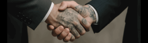 A close-up of two men in suits shaking hands, symbolizing a professional agreement or partnership.