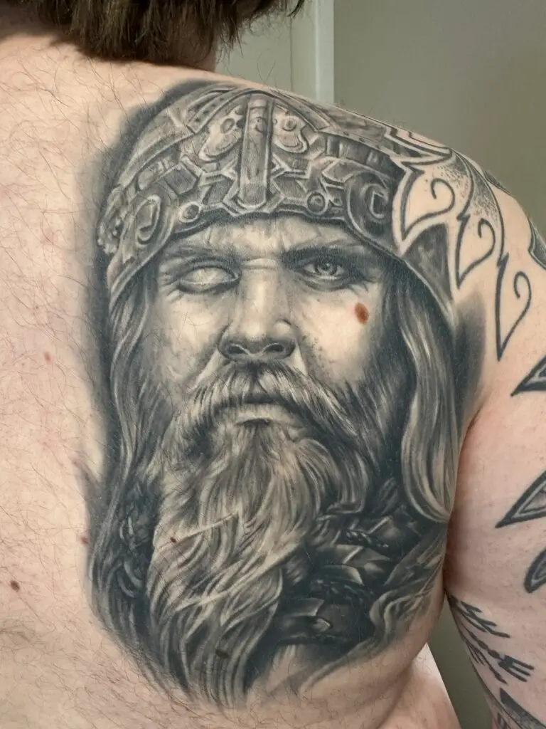 Realistisk vikingekriger tatovering i black and grey udført af tattoo Mini i København med ekstrem detaljegrad i hjelm, skæg og ansigtsudtryk